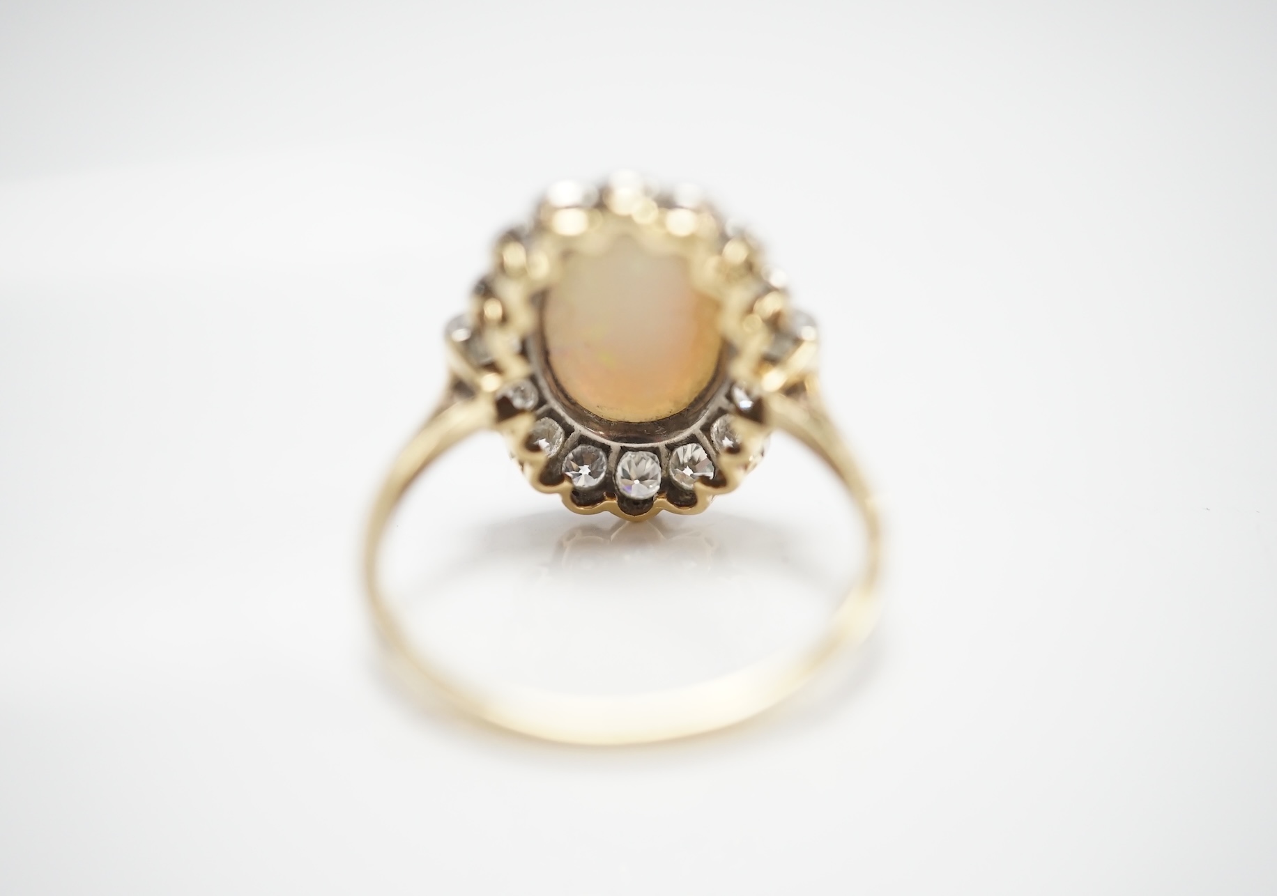 A mid 20th century 18ct, white opal, square and round cut diamond set oval cluster ring, size O, gross weight 3.3 grams. Condition - fair